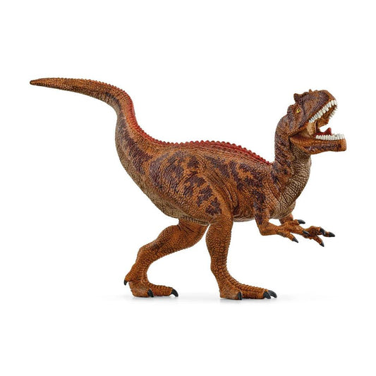 A light brown with dark brown speckles Allosaurus plastic figurine stands on two feet.. His head is reared back, mouth open baring teeth, and short arms in front.